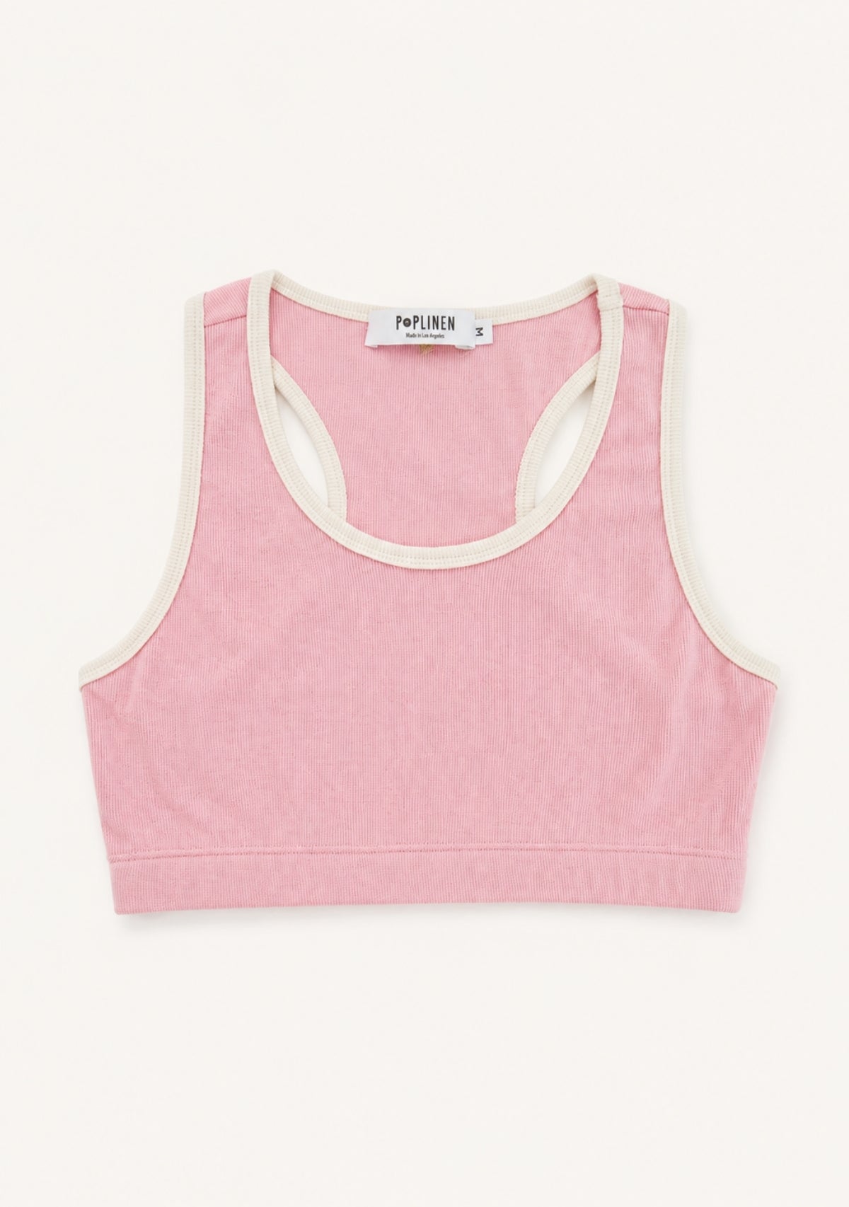 A pink cropped tank top with cream-colored trim, laid flat against a light off-white background. The brand name 'PORTA HER' is visible on the inner neck label.