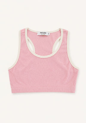 A pink cropped tank top with cream-colored trim, laid flat against a light off-white background. The brand name 'PORTA HER' is visible on the inner neck label.