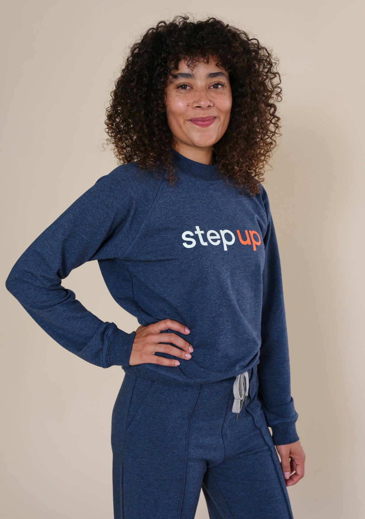 Side profile of Step Up x Poplinen crewneck sweatshirt with classic raglan sleeves and ribbed cuffs