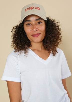 Cream Step Up baseball cap with embroidered front logo, curved brim and relaxed dad hat silhouette