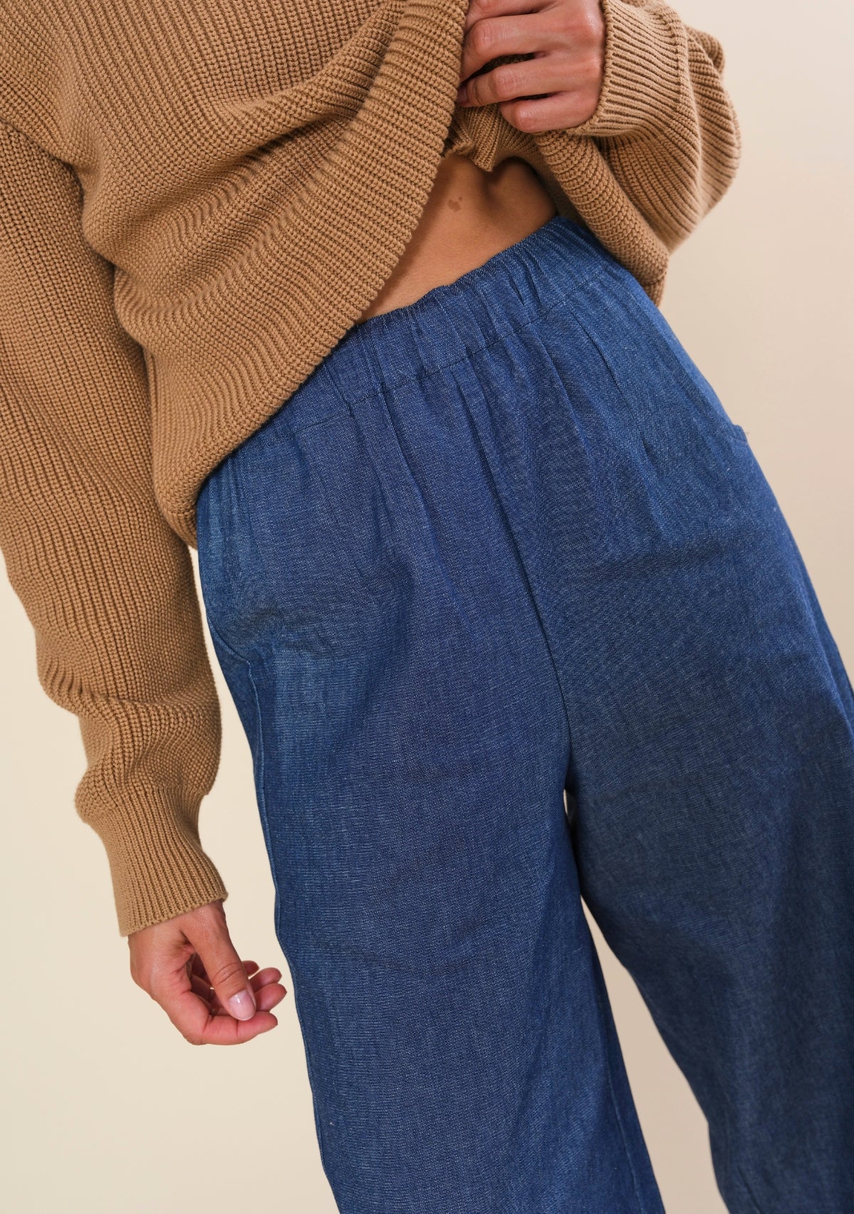 Close-up of Nin denim pants with elastic waistband and adjustable interior drawstring