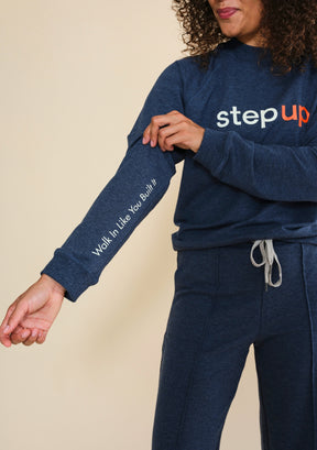 Close-up of Walk In Like You Built It slogan printed on right sleeve of Step Up raglan sweatshirt