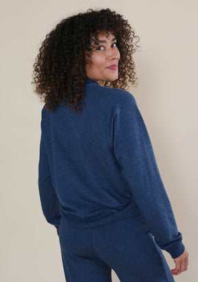 Back view of women's Step Up raglan crewneck sweatshirt with relaxed fit and ribbed hem