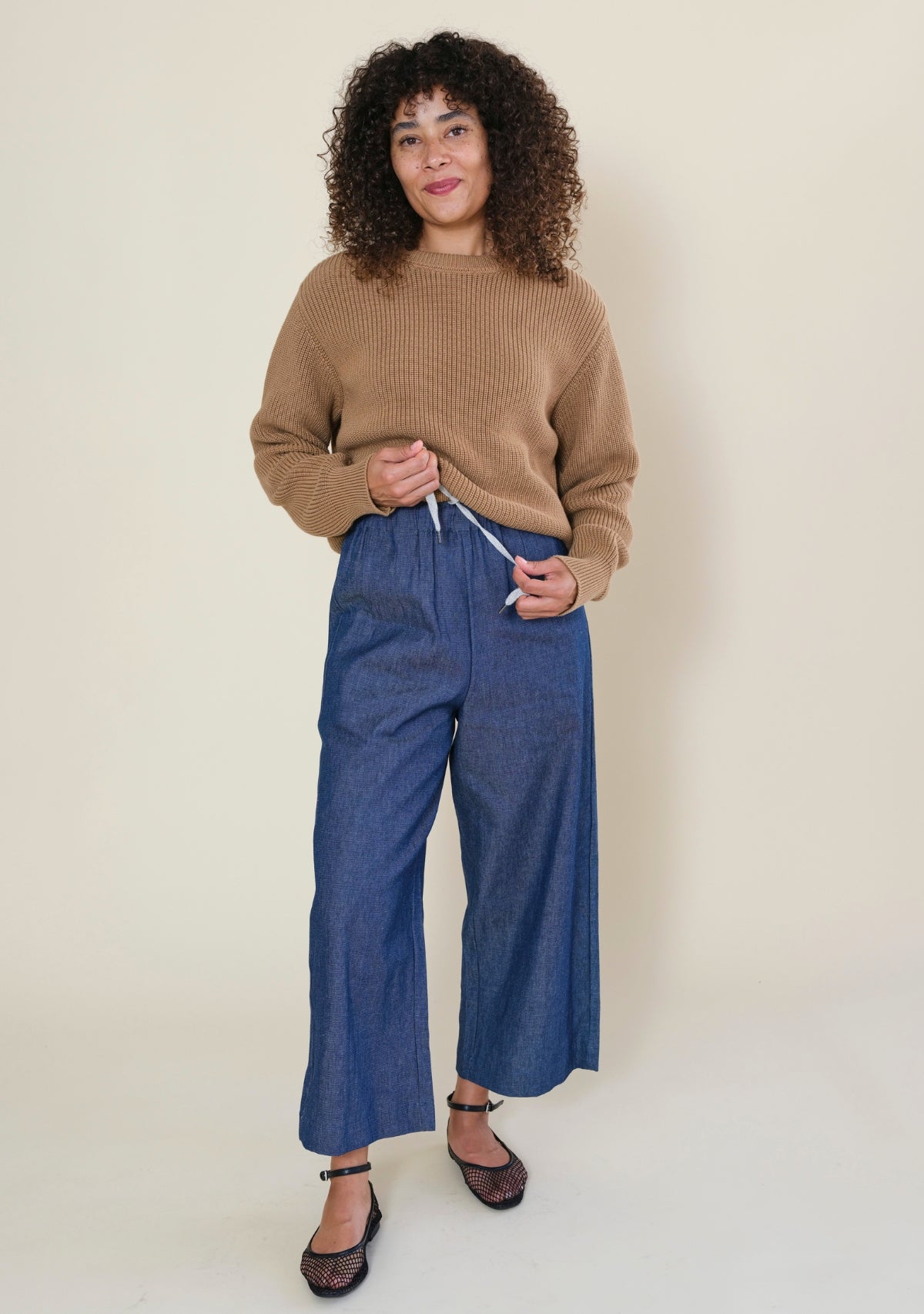 Close-up of Nin denim pants with elastic waistband and adjustable interior drawstring