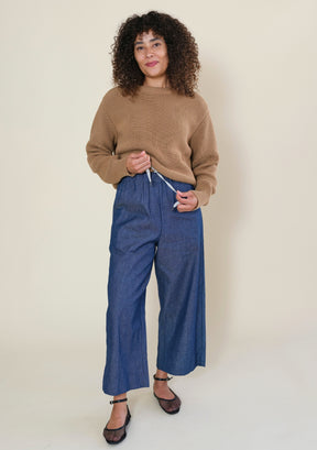 Close-up of Nin denim pants with elastic waistband and adjustable interior drawstring